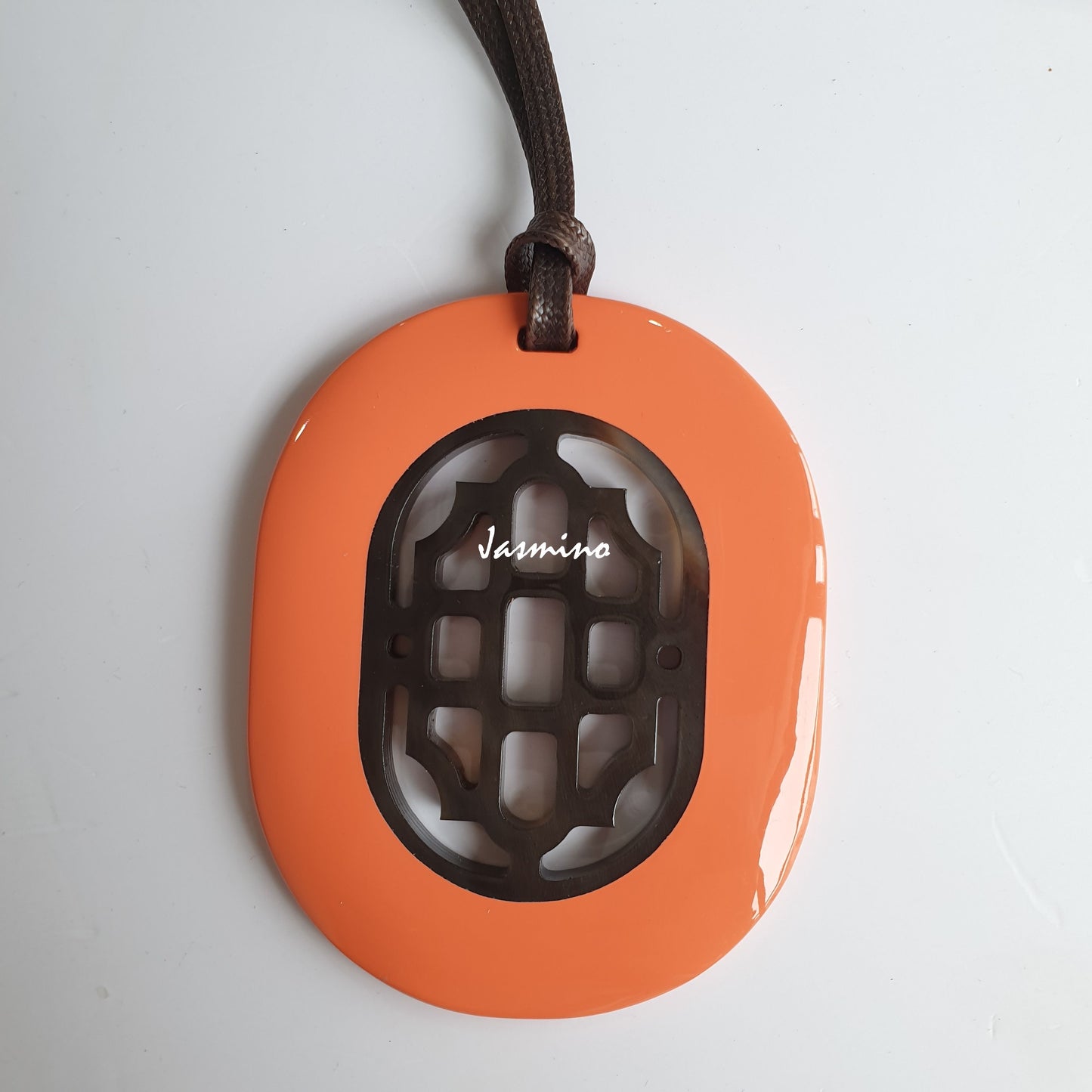 elliptical coral orange lacquer horn pendant with a unique pattern in natural light, impressive gift for her