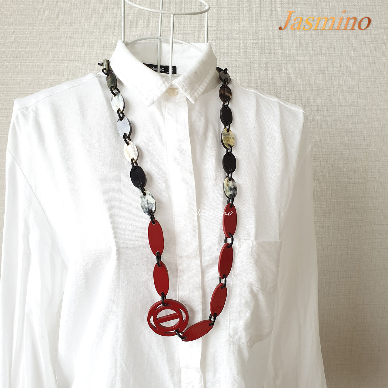 The necklace has some cherry pieces on the light background, a unique gift for her