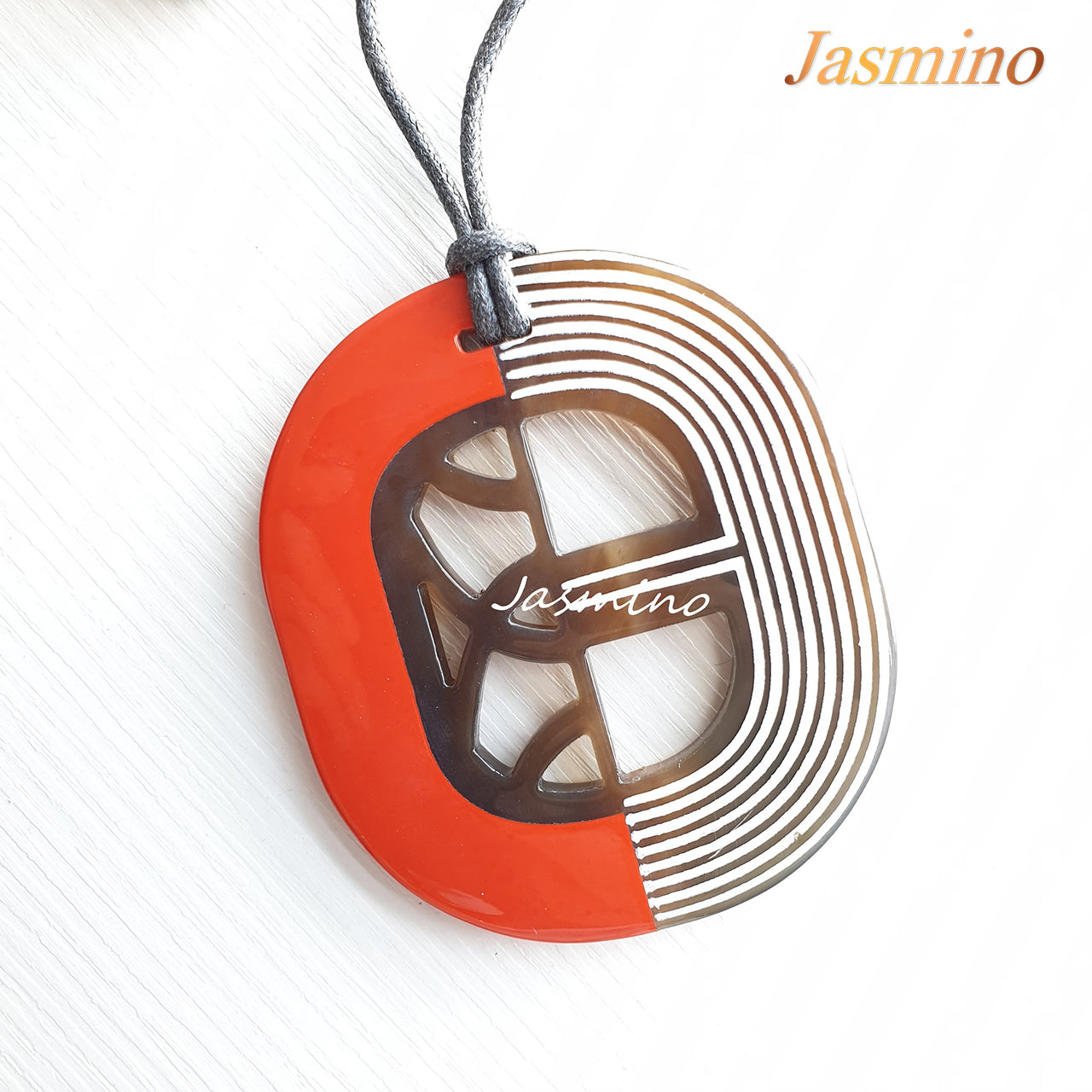 orange red lacquer pendant on the light background, impressive gift for her
