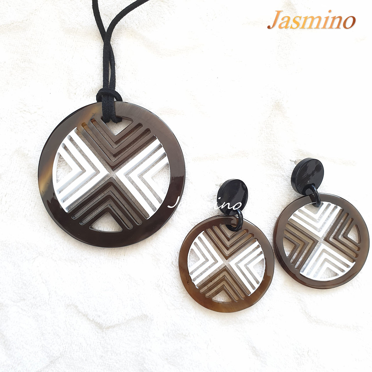 A set of unique circle white lacquer buffalo horn jewelry on the light background, impressive gift for your friend