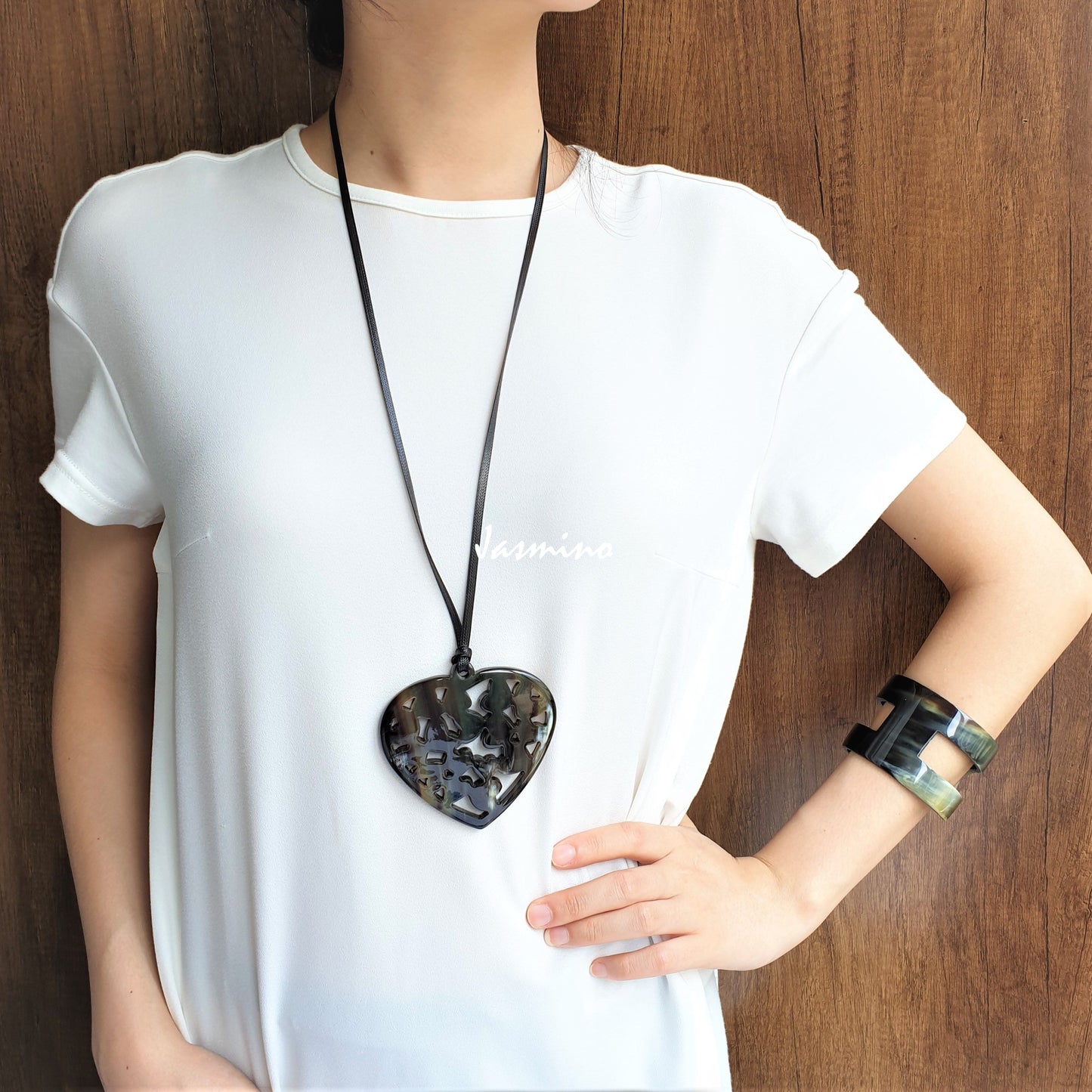 A women is wearing unique handmade pendant features heart shaped and natural buffalo horn for girls and couple jewelries