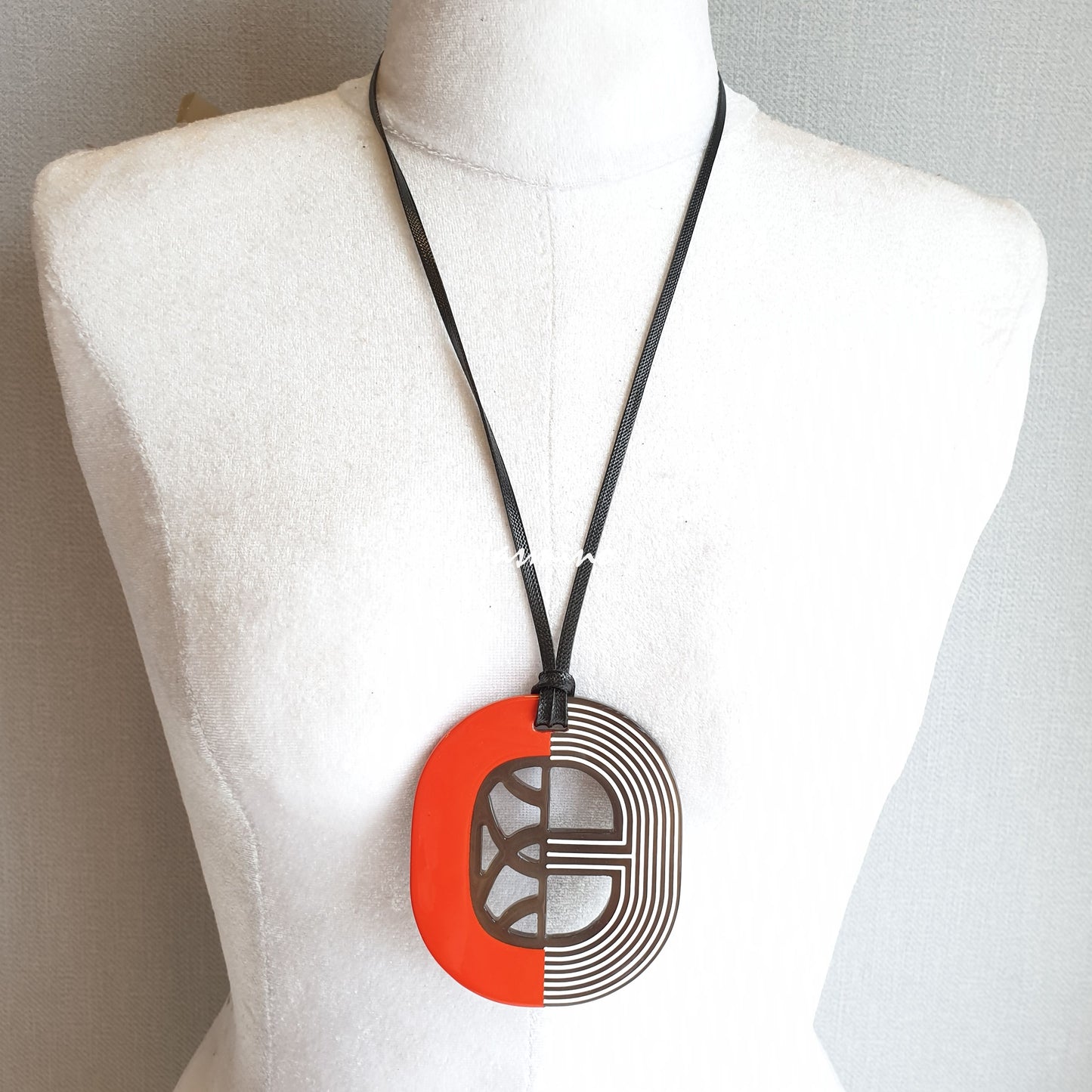 orange red lacquer pendant on the light background, impressive gift for her