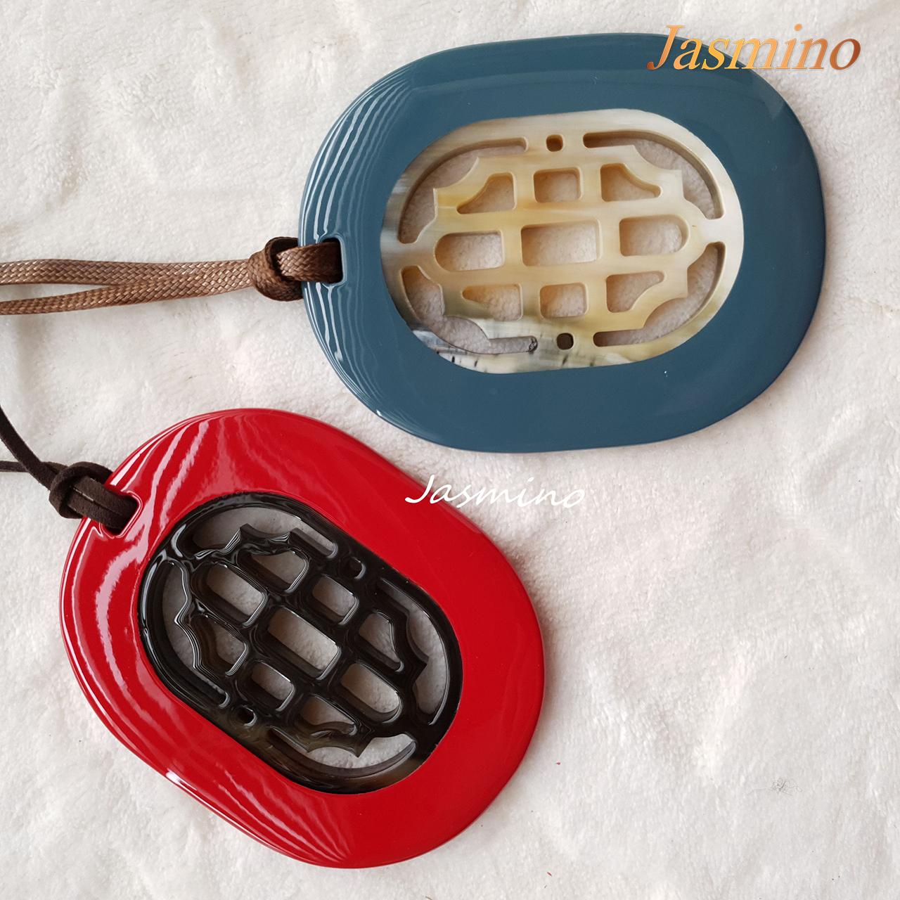 Two unique handmade oval pendants feature greyish-blue and red that are made of natural buffalo horn for Thanksgiving gifts