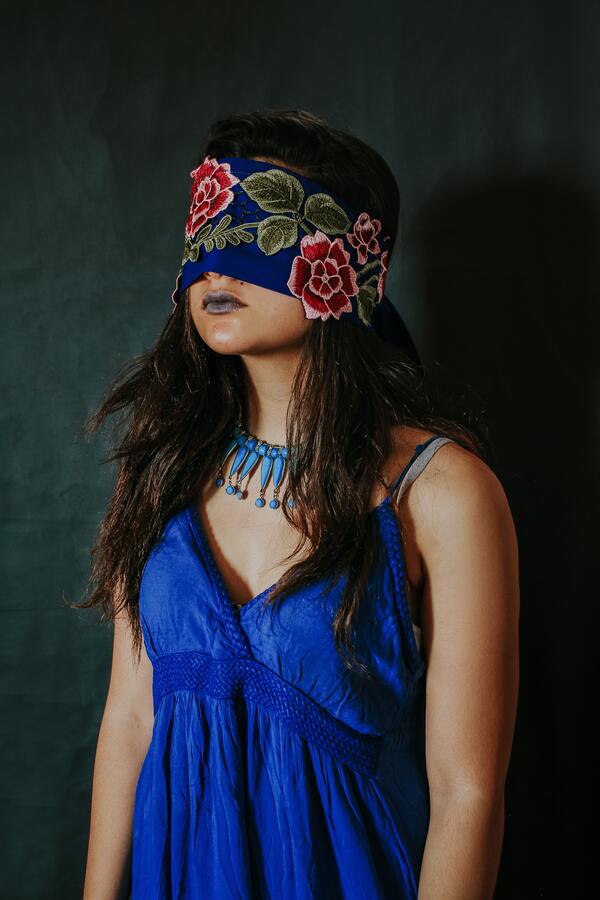 a girl wears blue dress and necklace