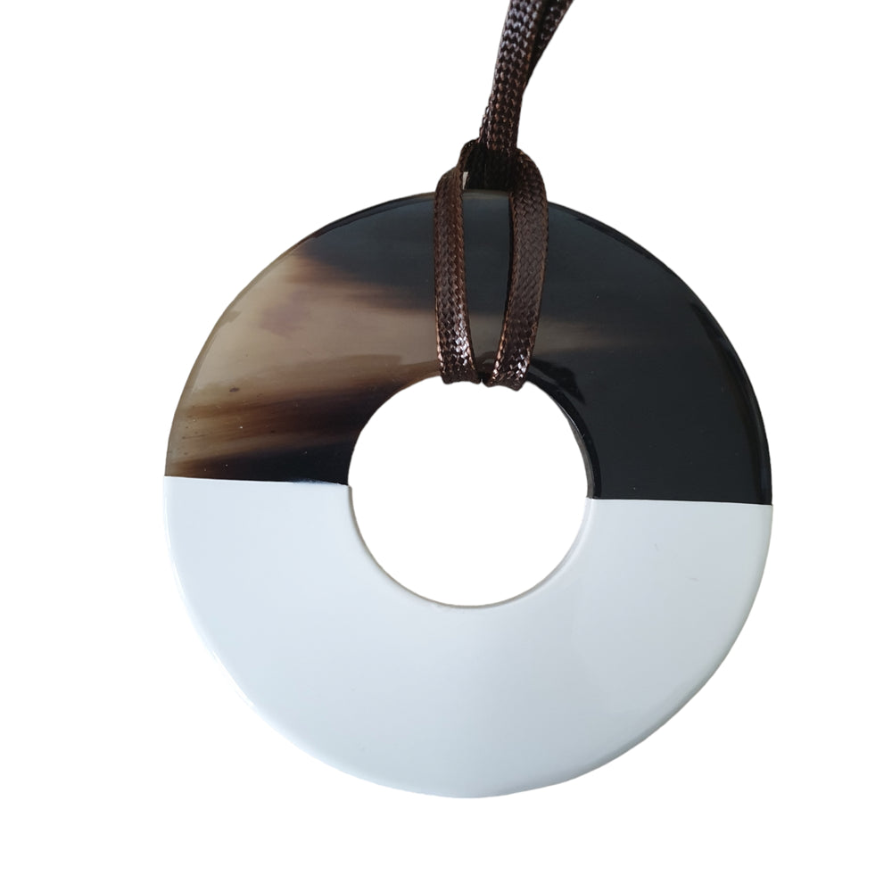 
                  
                    a round buffalo horn pendant
                  
                