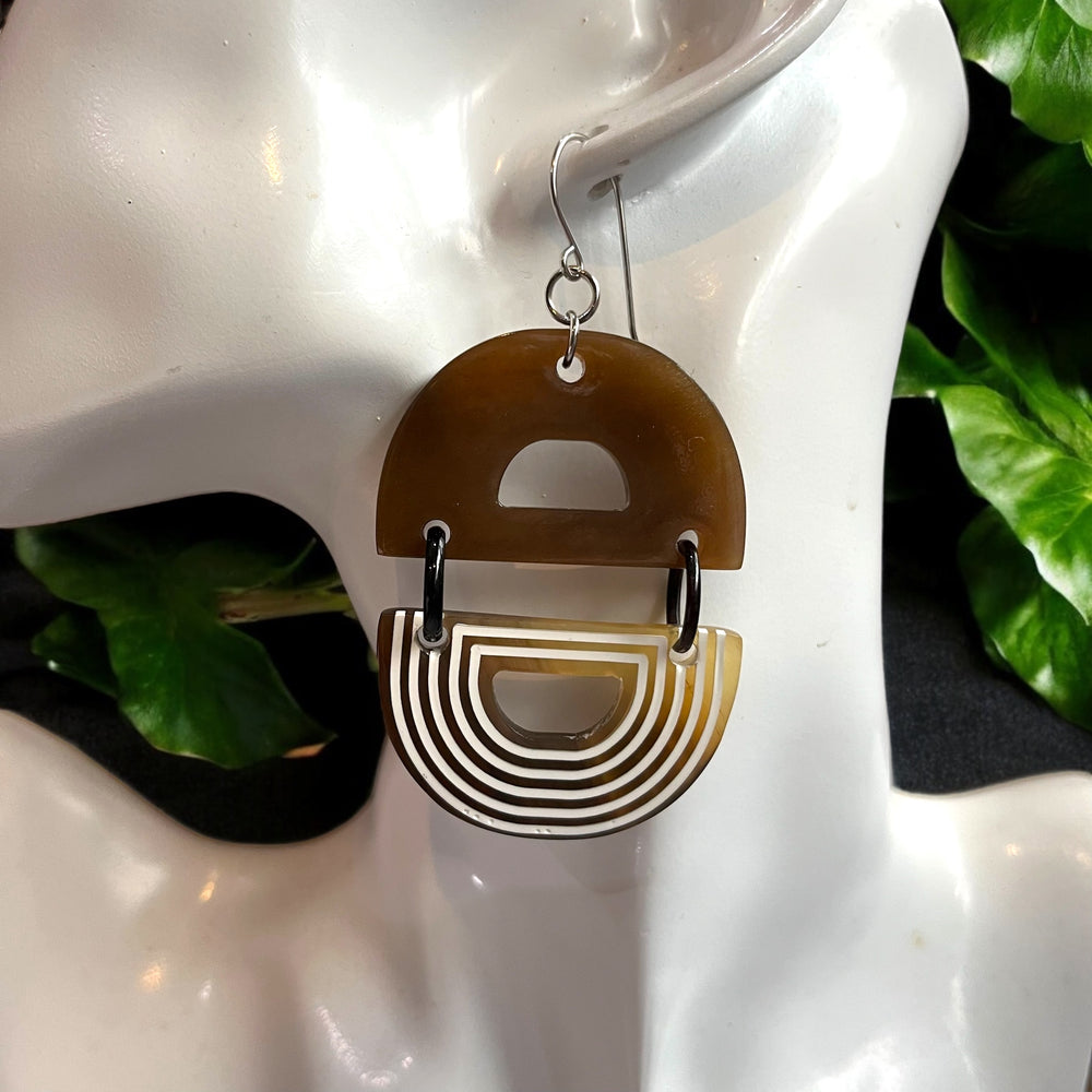 
                  
                    Handcrafted statement earrings made from natural buffalo horn, accented with sleek white lacquer lines and metal hooks.
                  
                
