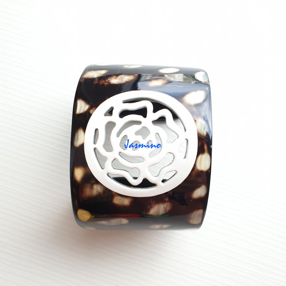 
                  
                    unique dark buffalo horn bracelet with a unique brilliant white flower pattern on a light background, an impressive gift for her
                  
                