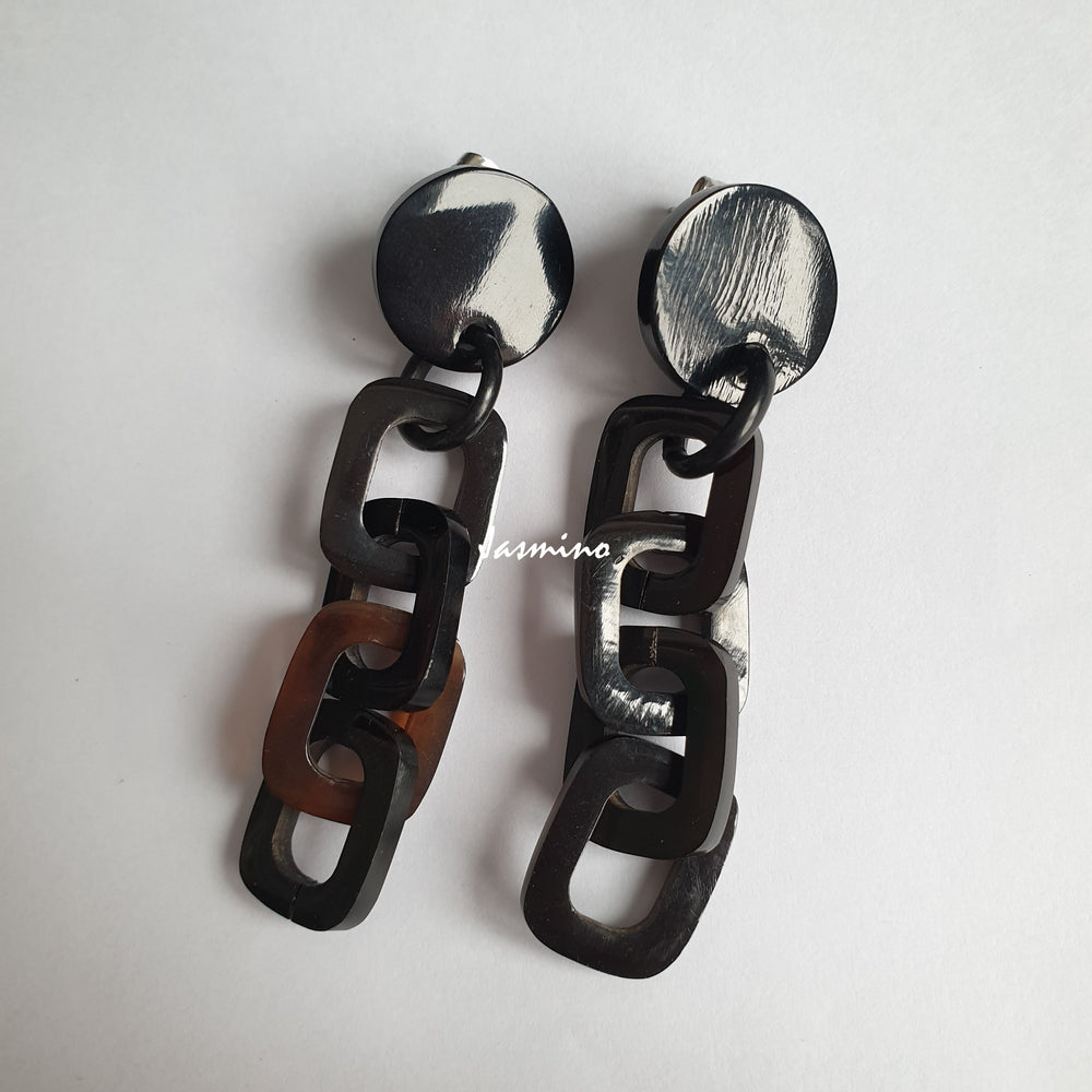 
                  
                    Handmade chain links earrings feature dark colours and natural buffalo horn material on  a white background
                  
                