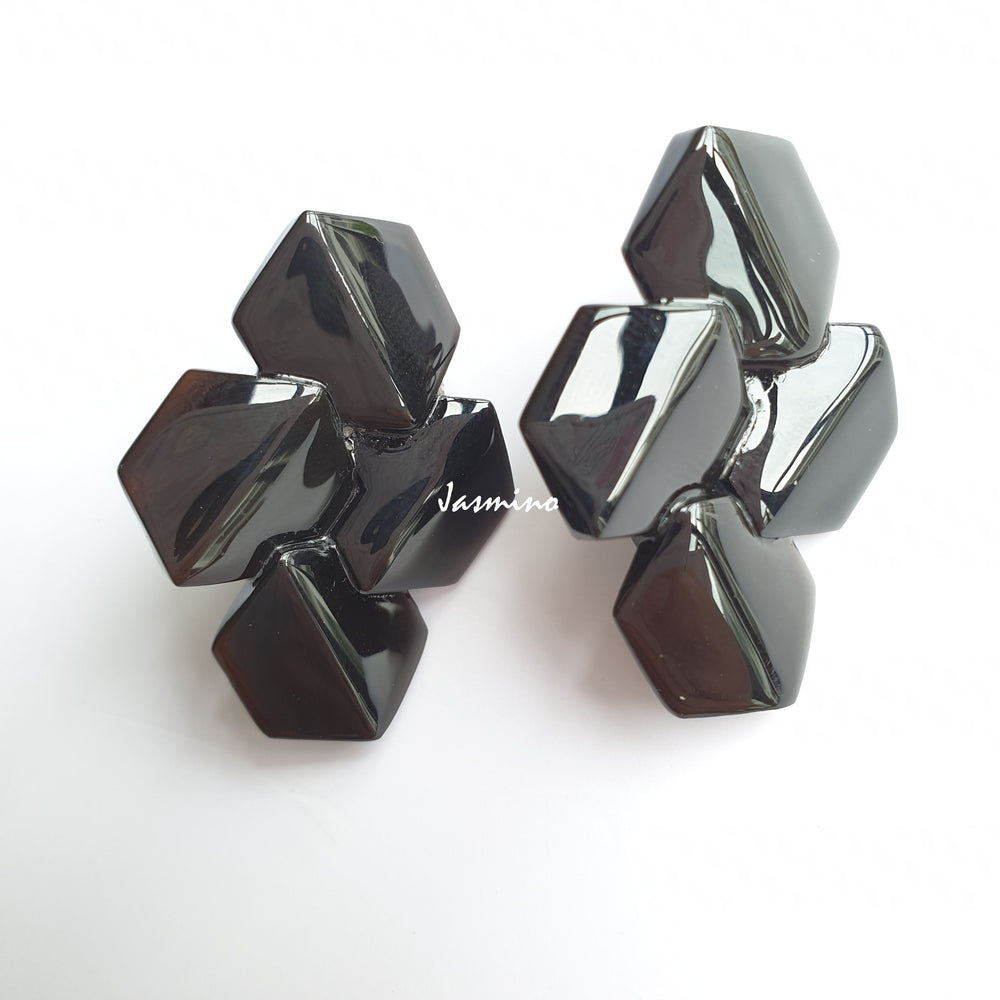 
                  
                    Handmade Geometric Earrings feature black and natural buffalo horn with a bee hive shape in the natural light
                  
                