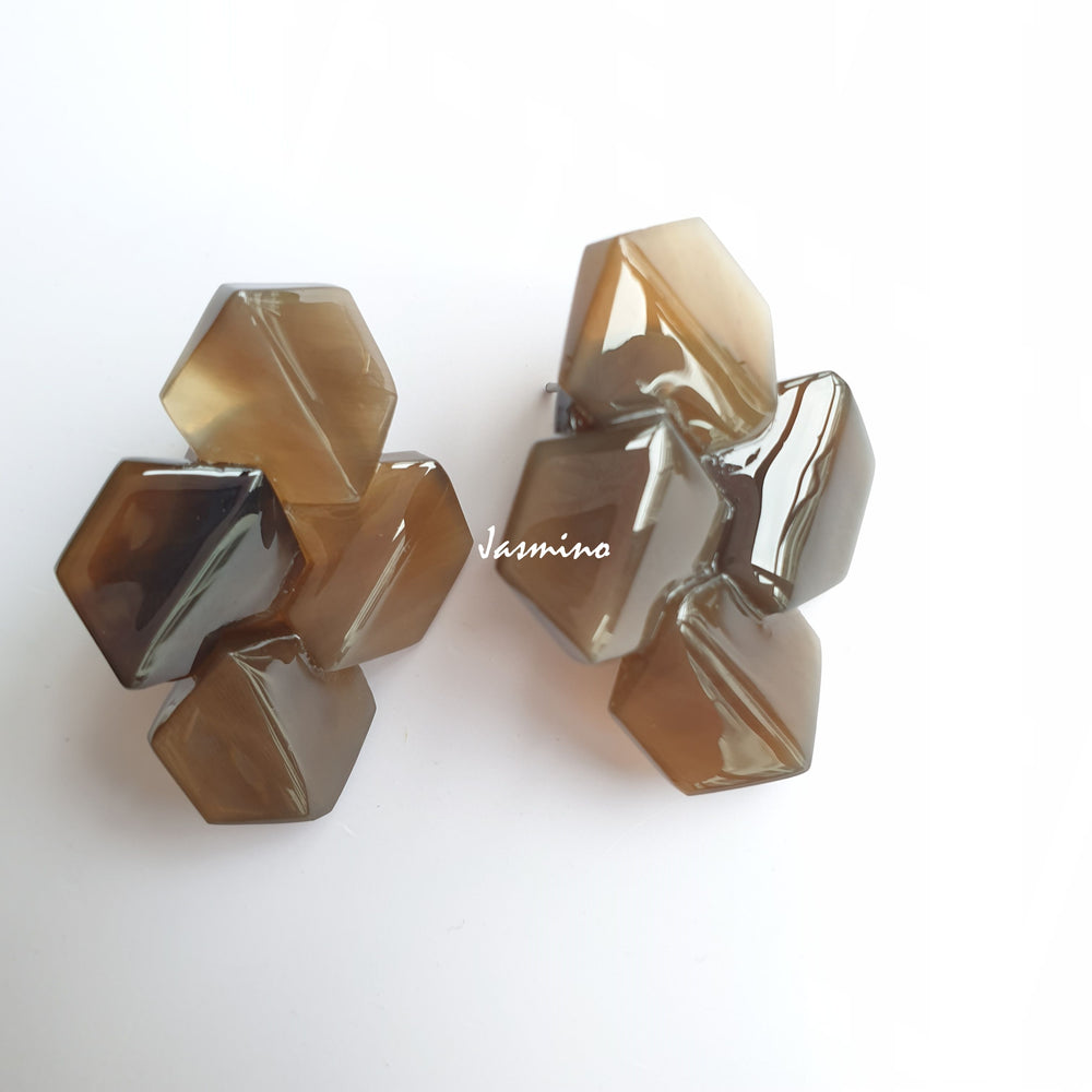 
                  
                    Handmade Geometric Earrings feature honey brown and natural buffalo horn with a bee hive shape in the natural light
                  
                