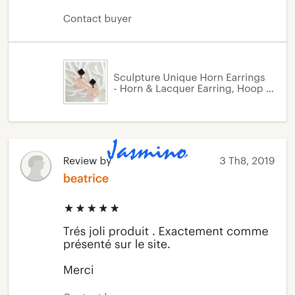
                  
                    Customers give positive feedback to a handmade jewelry collection in a shop
                  
                