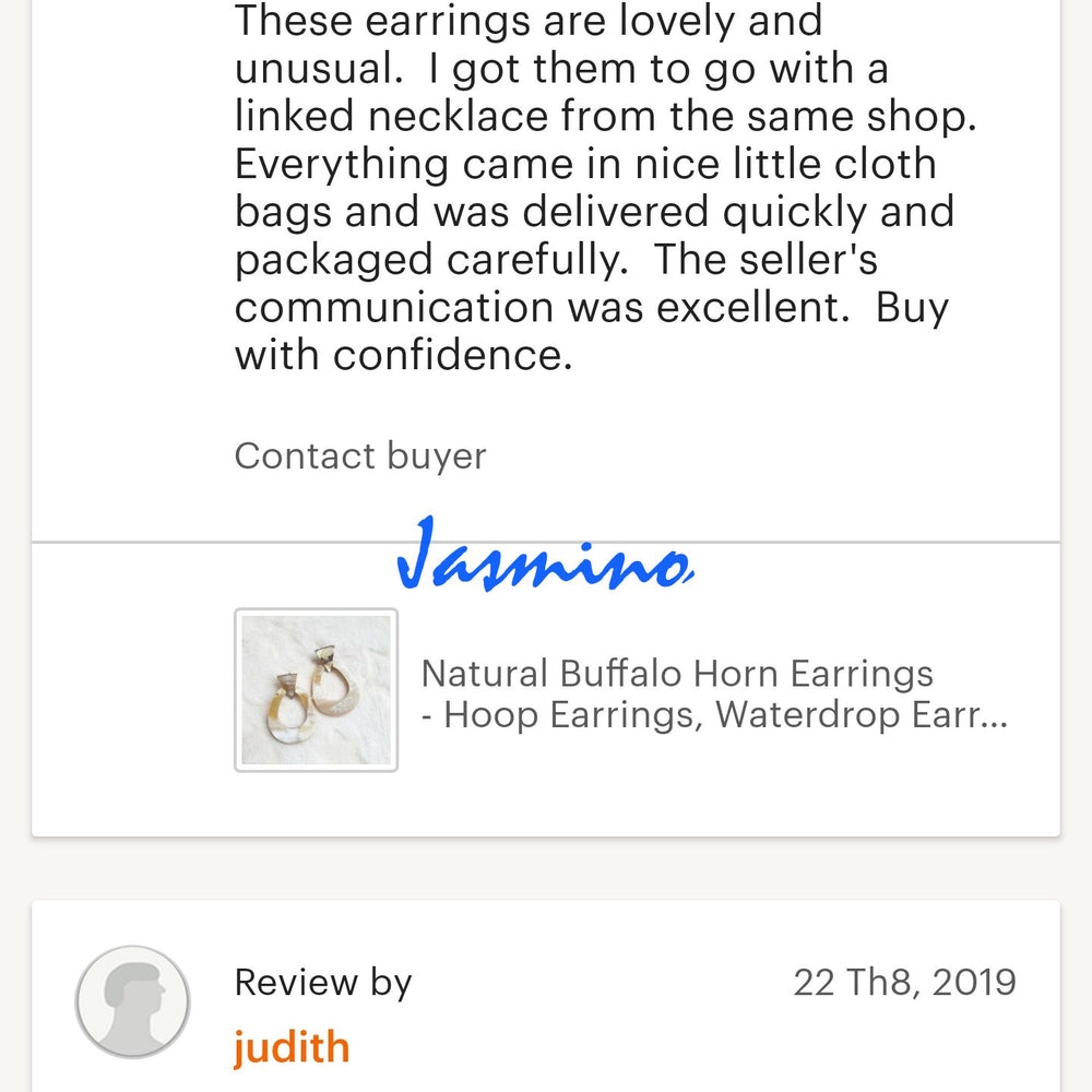 
                  
                    Two customers give good reviews to a jewelry collection in a handmade shop
                  
                