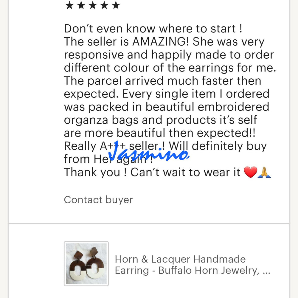 
                  
                    Two customers give positive feedback for a handmade jewelry collection in a shop
                  
                