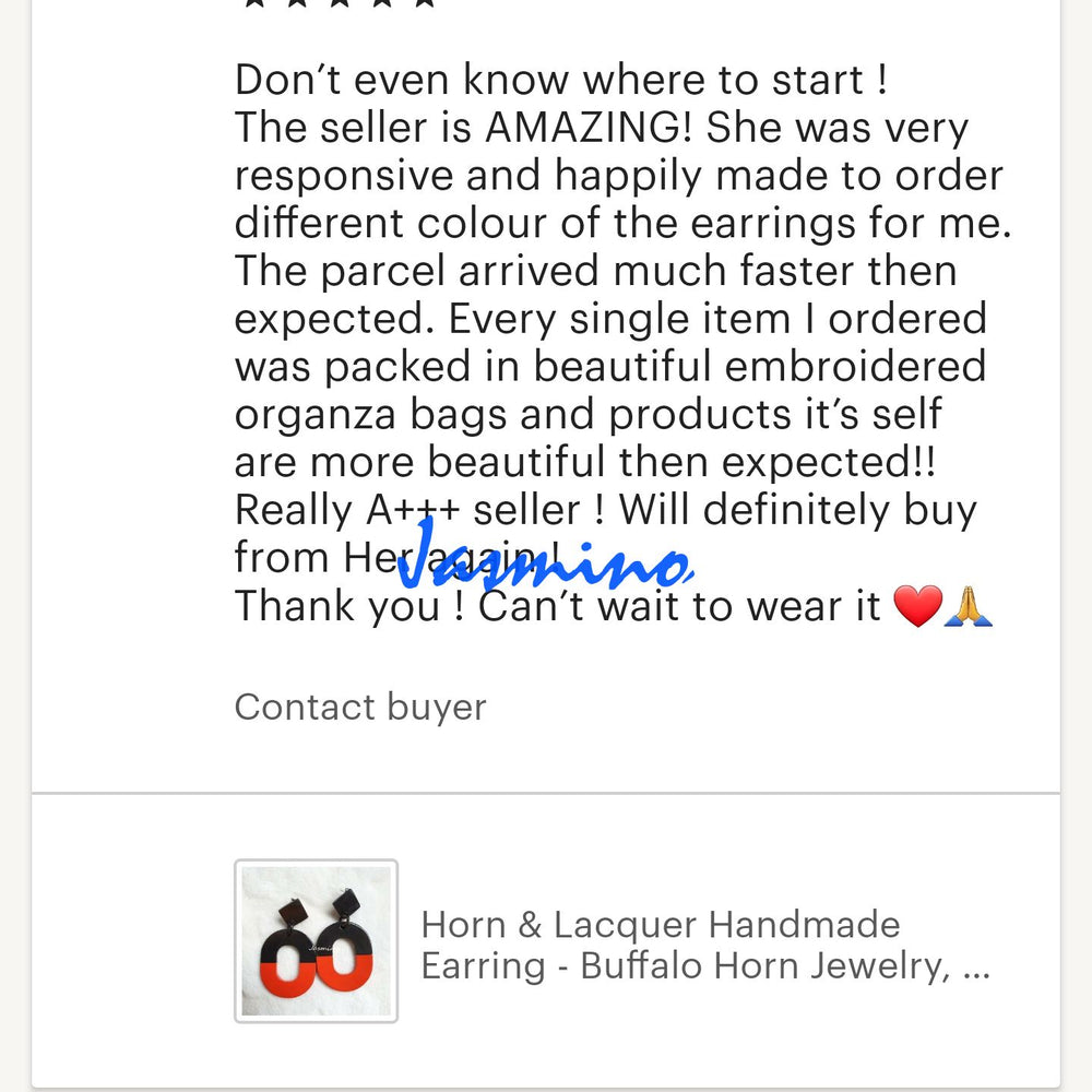 
                  
                    Two customers give positive feedback for a handmade jewelry collection in a shop
                  
                