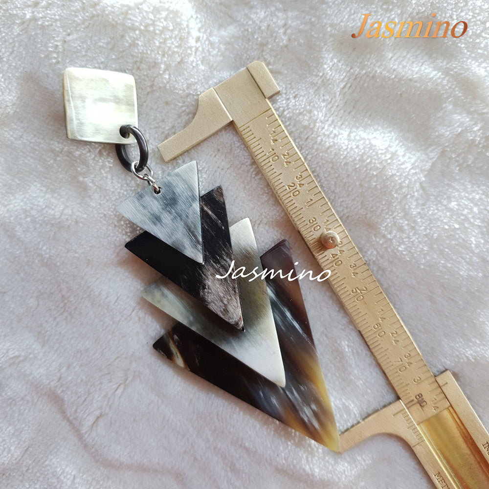 
                  
                    Jasmino unique handmade Vintage drop earrings feature alternating triangles made of natural buffalo horn
                  
                
