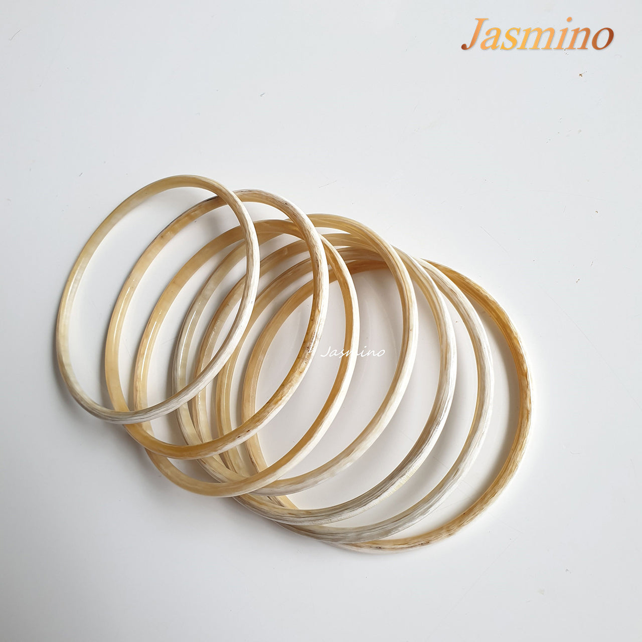 set of seven circle bright buffalo horn bracelets on a white background, an impressive gift for her