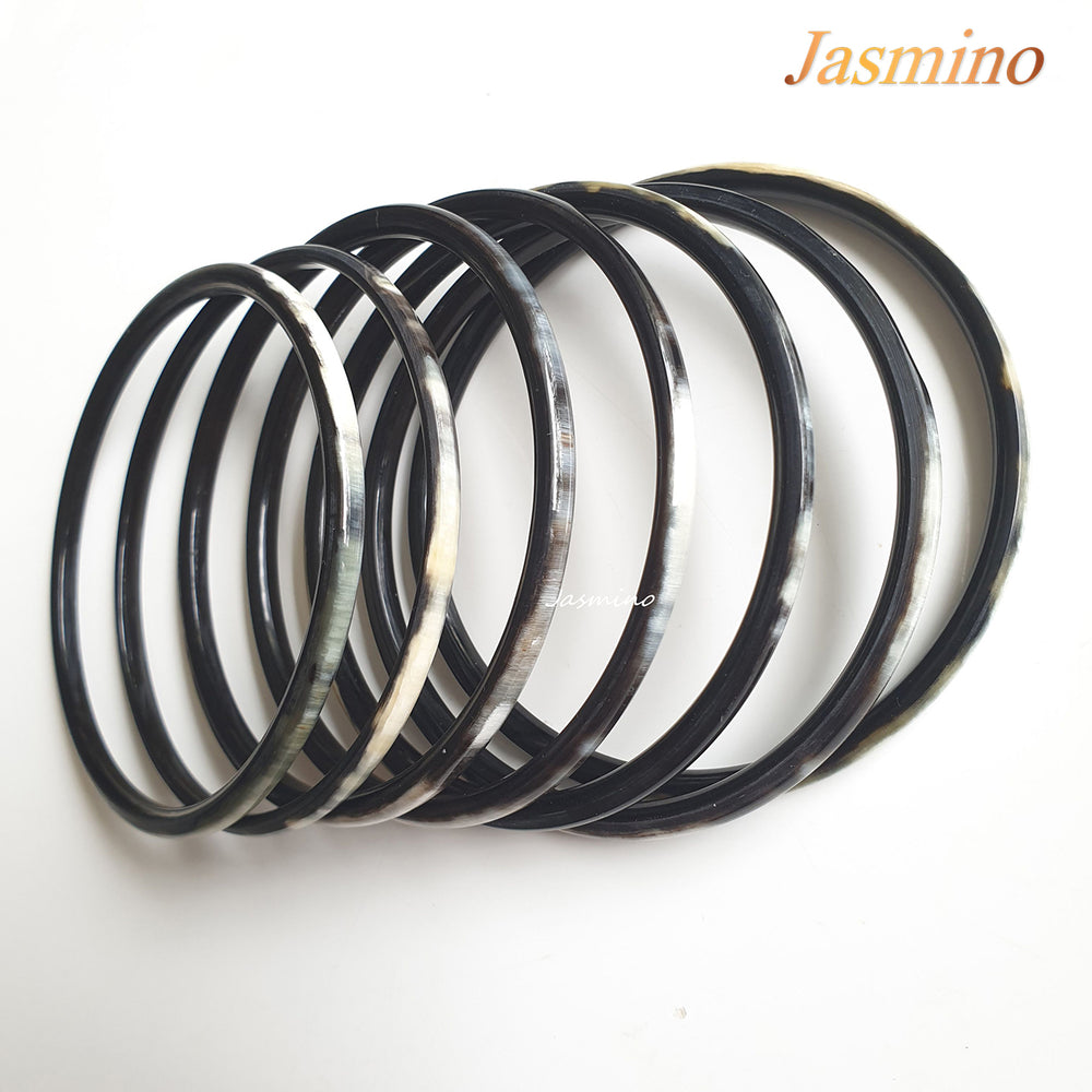 
                  
                    set of seven circle dark buffalo horn bracelets on a light background, an impressive gift for her
                  
                