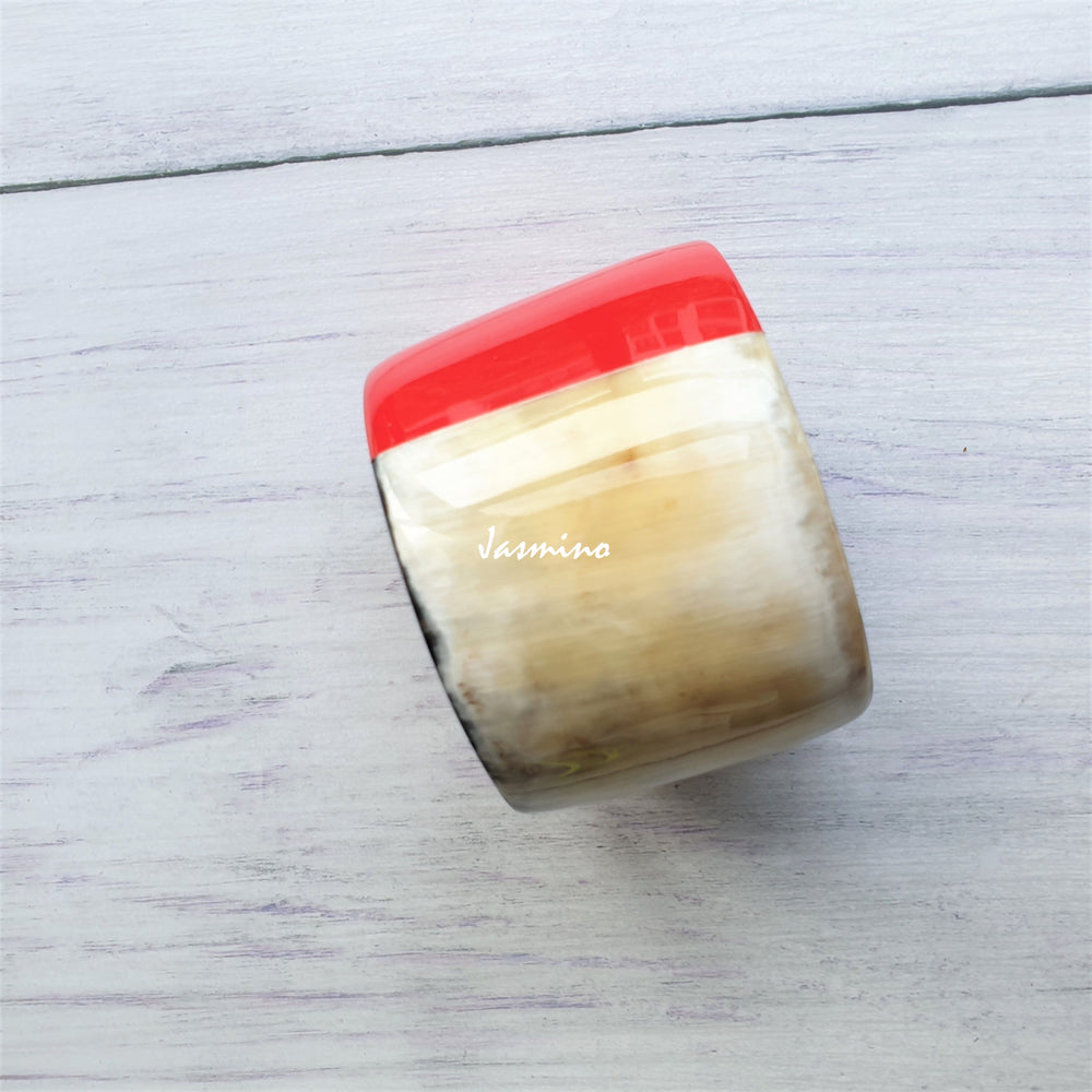 
                  
                    Jasmino unique handmade Christmas bangle bracelet features a red half and white half in natural buffalo horn for women
                  
                