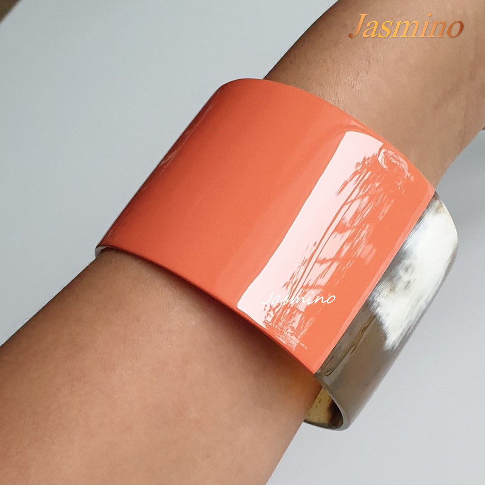 
                  
                    A mode is wearing bracelet designed with half natural buffalo horn and half orange peel lacquer in natural light, unique gift for her
                  
                
