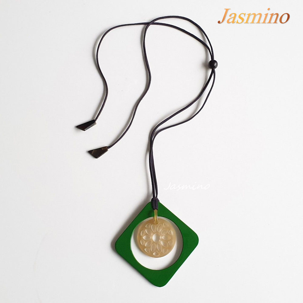 
                  
                    green rhombus pendant on the light background, impressive gift for her on Christmas 
                  
                