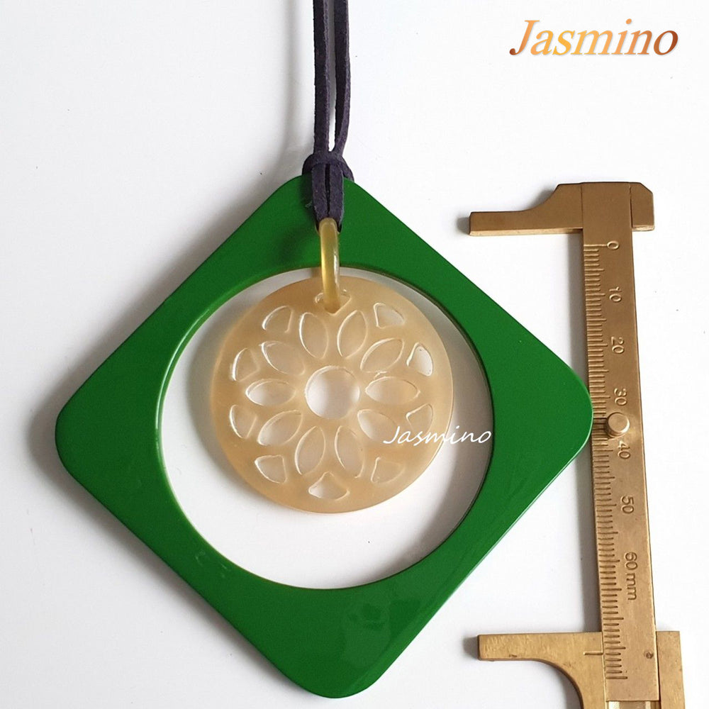 
                  
                    green rhombus pendant on the light background, impressive gift for her on Christmas 
                  
                