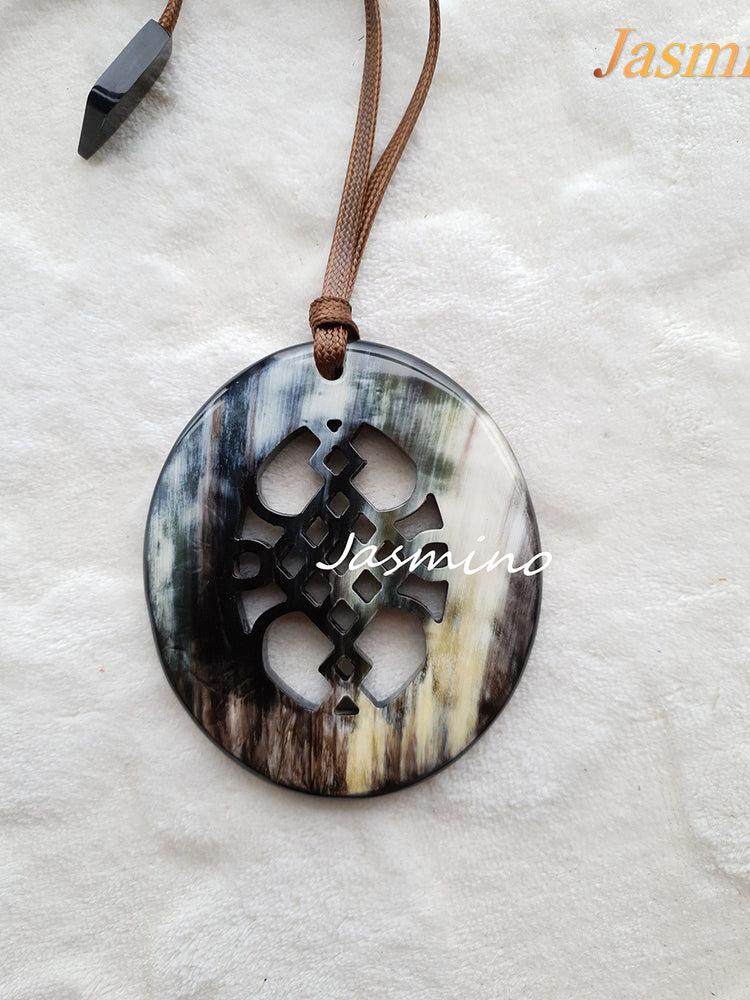 
                  
                    unique natural dark horn pendant on the light background, impressive gift for her
                  
                