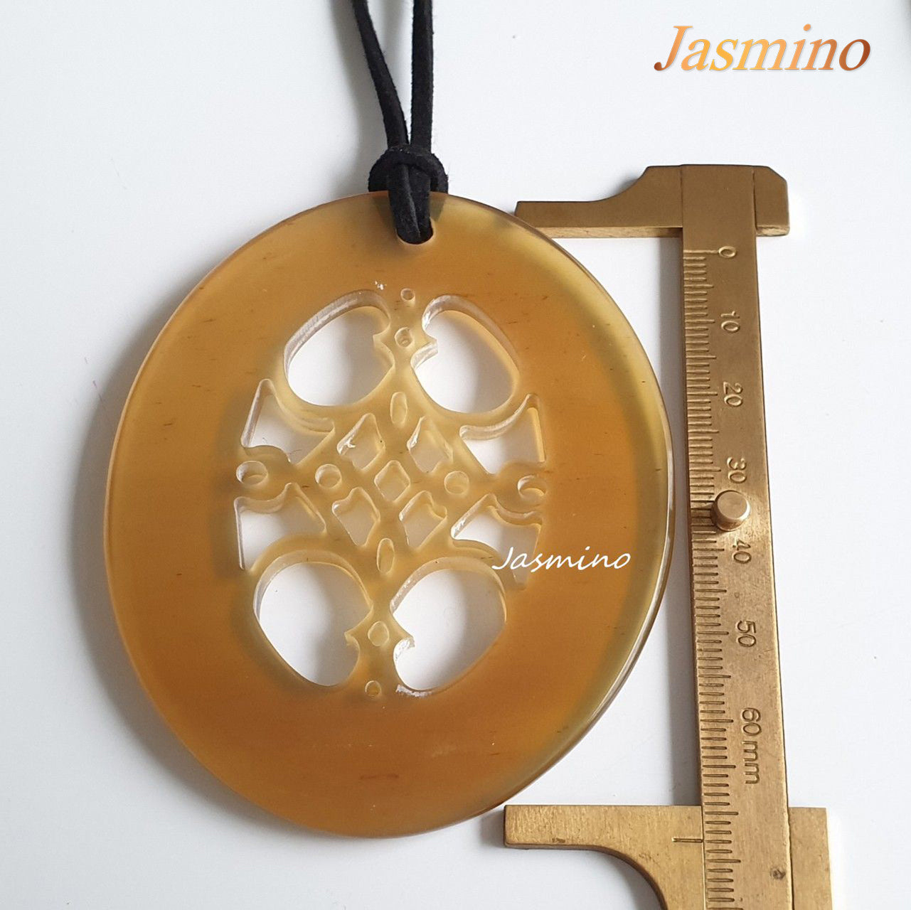 unique natural honey horn pendant on the light background, impressive gift for her