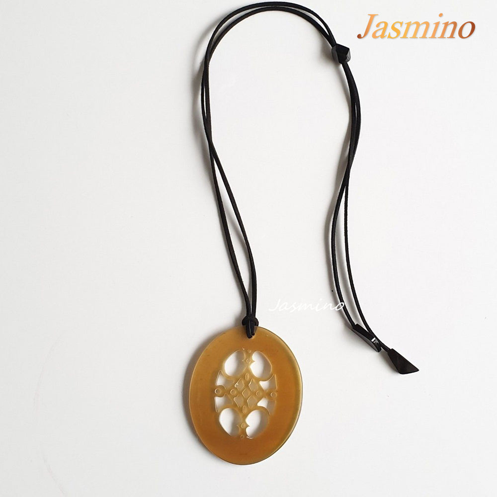 
                  
                    unique natural honey horn pendant on the light background, impressive gift for her
                  
                
