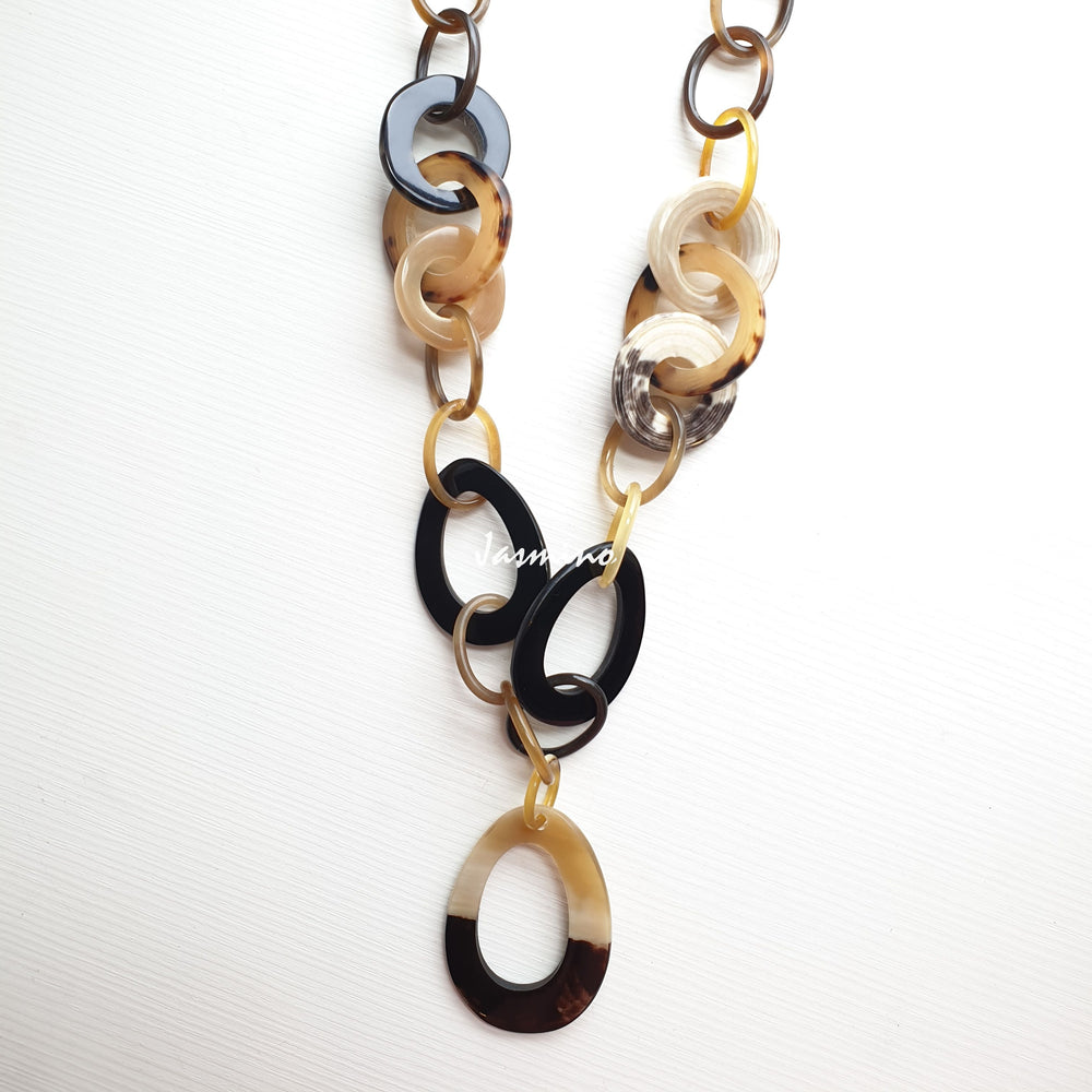 
                  
                    The necklace has some large brilliant black pieces on the light background, a unique gift for her
                  
                