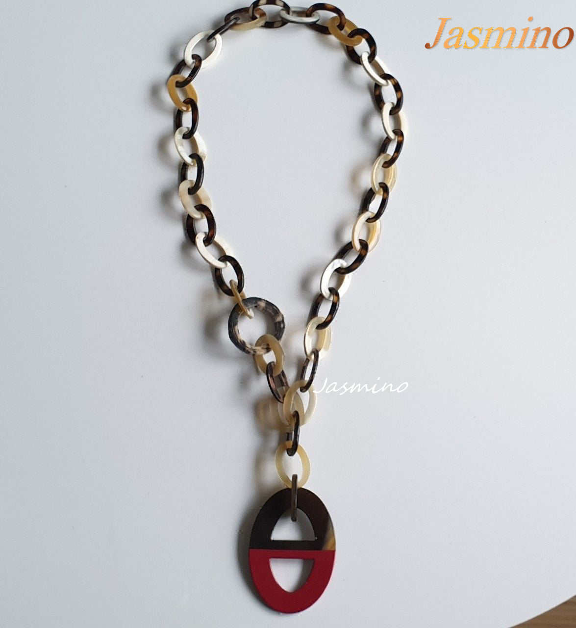 buffalo horn necklace has the largest ellipse with half natural buffalo horn and half painted pink in natural light, an impressive gift for her