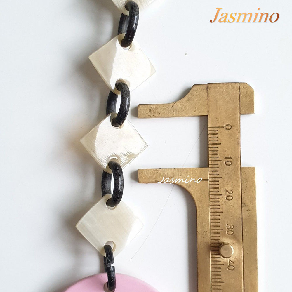 
                  
                    This necklace is made of natural lozenge buffalo horn pieces and four circle blue horn pieces with a unique pattern stands out on a light background, is a unique gift for friends
                  
                