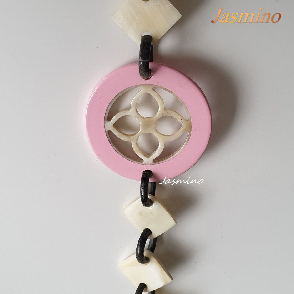 
                  
                    This necklace is made of natural lozenge buffalo horn pieces and four circle pink horn pieces with a unique pattern stands out on a light background, is a unique gift for friends
                  
                