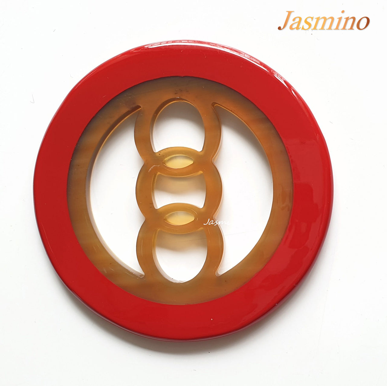 circular pendant with orange red outline, inside with unique pattern made from natural buffalo horn on the light background, impressive gift for her 