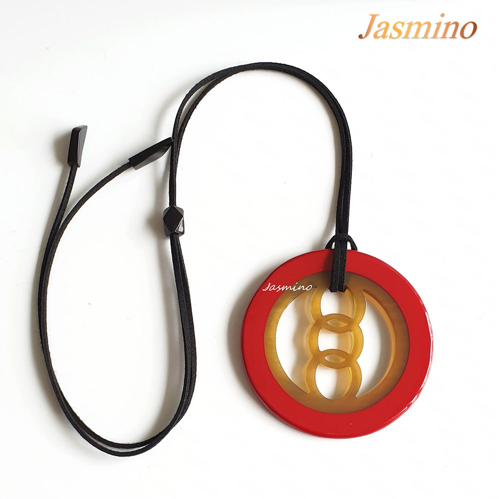 
                  
                    circular pendant with red outline, inside with unique pattern made from natural buffalo horn on the light background, impressive gift for her
                  
                