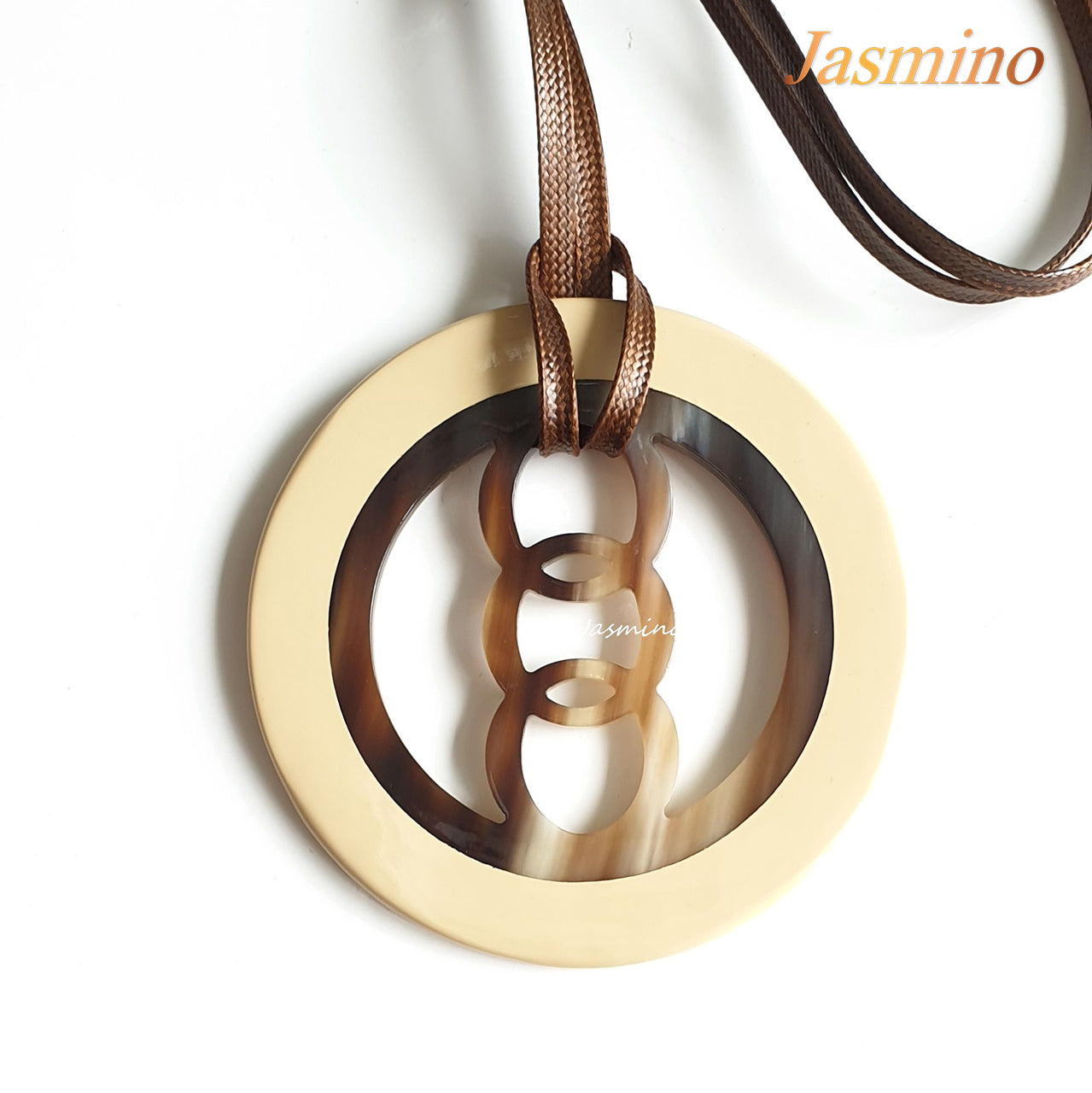 circular pendant with beige outline, inside with unique pattern made from natural buffalo horn on the light background, impressive gift for her 
