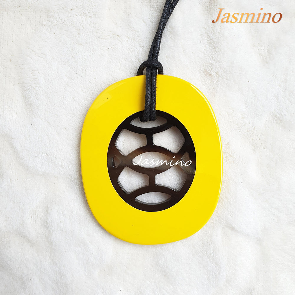 
                  
                    elliptical pendant is designed with a yellow outline, inside with a unique natural buffalo horn pattern on the light background, impressive gift for her
                  
                