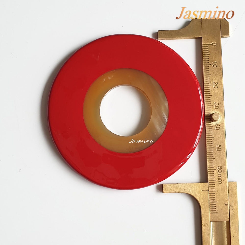 
                  
                    round red maple horn pendant on the light background, impressive Christmas gift for her
                  
                