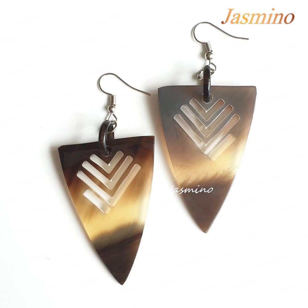 Triangle dangle earrings feature an arrow shape with amber color in the natural light 