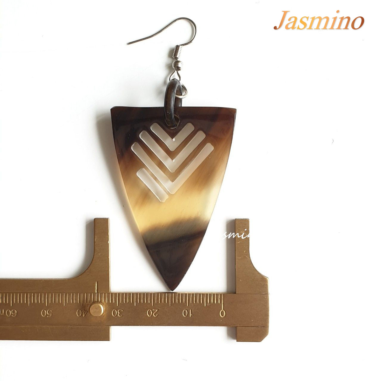 Triangle dangle earrings feature an arrow shape with amber color in the natural light 