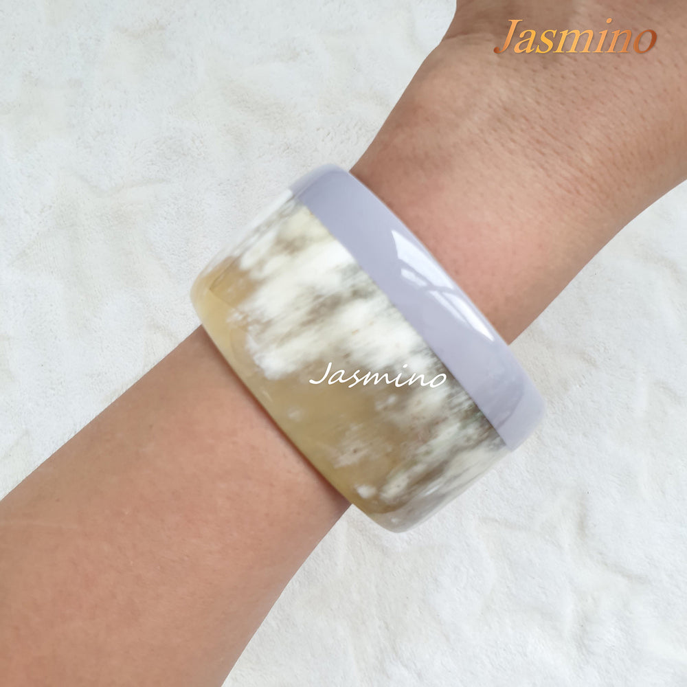
                  
                    round serenity lacquer buffalo horn bracelet on the light background, unique gift for her
                  
                