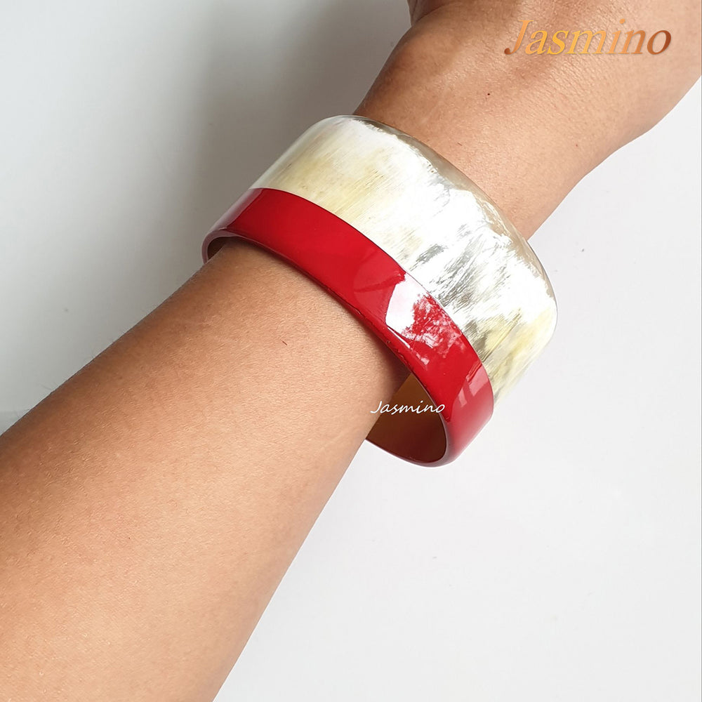 
                  
                    A model is wearing round red lacquer buffalo horn bracelet on the light background, unique gift for her
                  
                