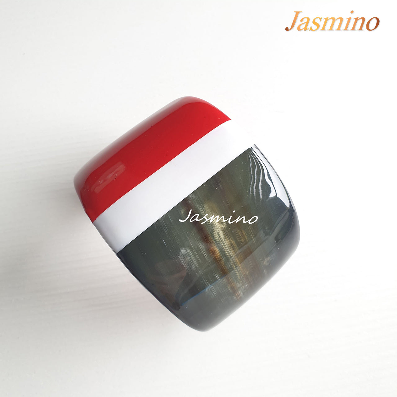  brilliant white- scarlet lacquer buffalo horn bracelet on the light background, impressive Christmas gift for her