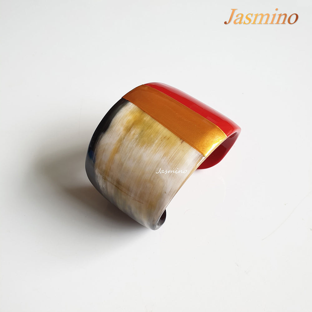 
                  
                     bronze- scarlet lacquer buffalo horn bracelet on the light background, impressive Christmas gift for her
                  
                