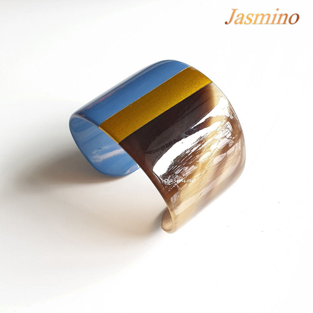 
                  
                     bronze- azure blue lacquer buffalo horn bracelet on the light background, impressive gift for her
                  
                