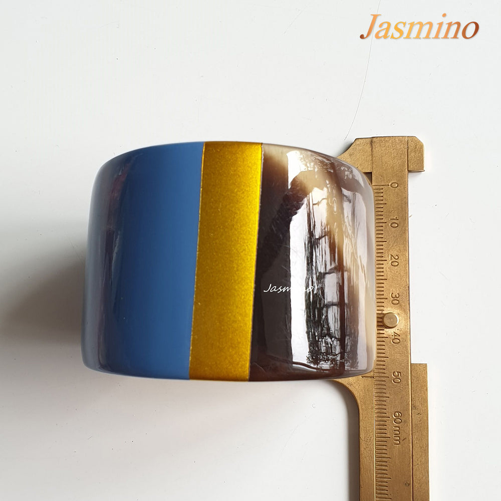 
                  
                     bronze- azure blue lacquer buffalo horn bracelet on the light background, impressive gift for her
                  
                