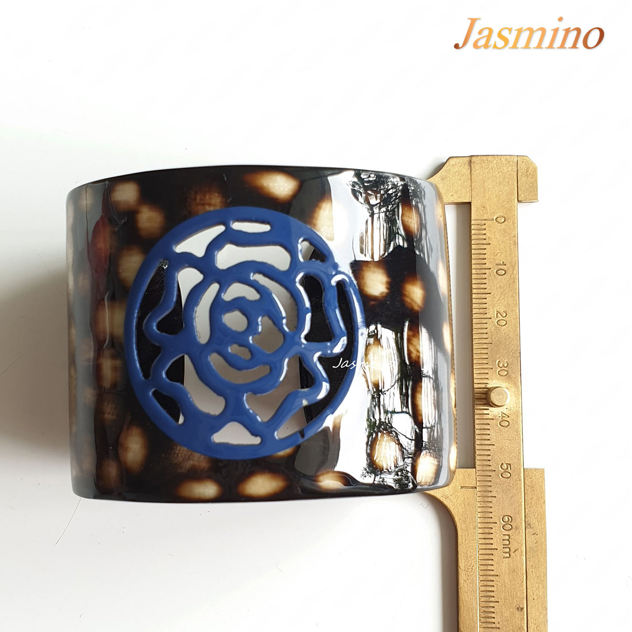 unique dark buffalo horn bracelet with a unique princess blue flower pattern on a light background, an impressive gift for her