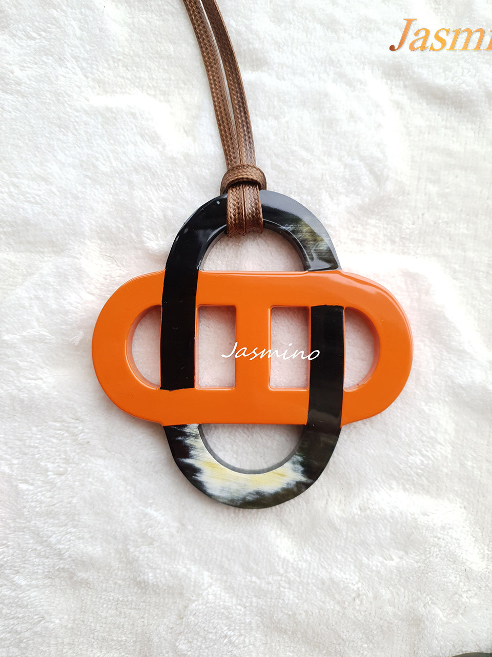 orange lacquer pendant on the light background, impressive gift for her