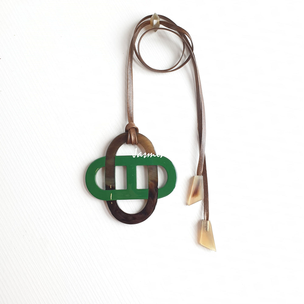 
                  
                    Green lacquer pendant on the light background, impressive Christmas gift for your friends
                  
                