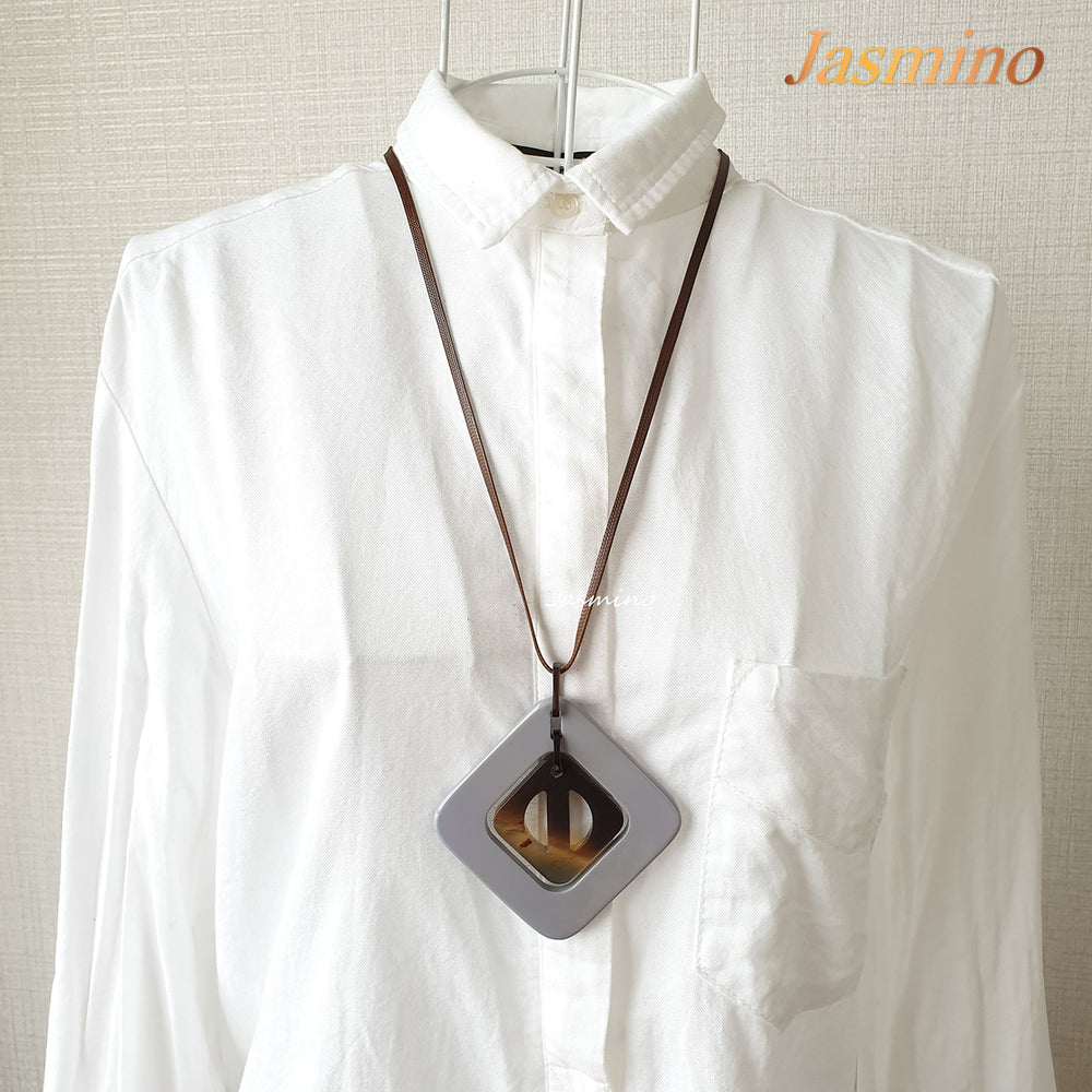 
                  
                    purple rhombus pendant on the light background, impressive gift for her
                  
                