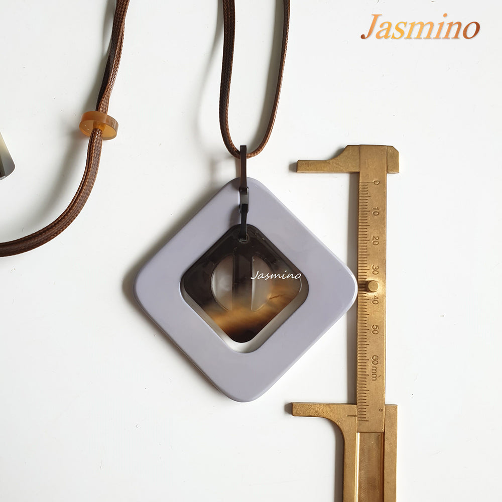 
                  
                    purple rhombus pendant on the light background, impressive gift for her
                  
                